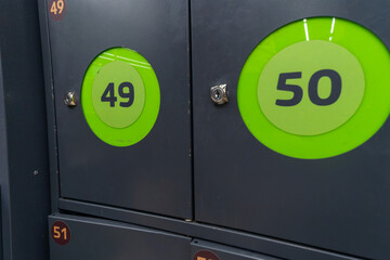 Simple locker storage with numbered keys. Secure bag storage lockers with numbered keys convenient for shoppers keeping their belongings safe while browsing in retail environments.