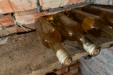 Rustic Wine Cellar Filled With Aging Bottles On Wooden Shelves. A Detailed View Of A Rustic Wine Cellar Filled With Carefully Aged Bottles On Wooden Shelves.