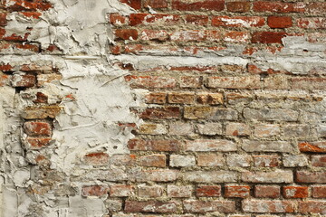 Old brick wall texture, weathered red bricks, rustic surface, exposed mortar, uneven brickwork, chipped and crumbling areas, historic building facade, vintage construction, urban decay aesthetic, arch
