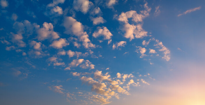Fototapeta Sunset with bright sun, blue sky and pink clouds
