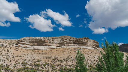 Layered Rock Formation and Clouds in the Nevada Desert