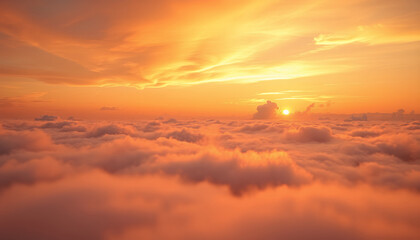 Obraz premium Majestic sunset over a sea of clouds, with the sun casting a warm orange glow