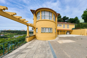 The striking yellow Casa do Roseiral near Jardim do Roseiral on a hill next to the Crystal Palace...