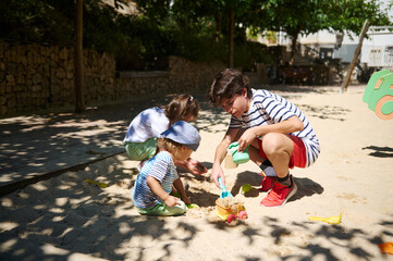 Children Enjoying Playtime Together Outdoors in a Sunny Playground