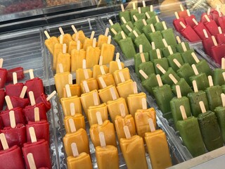 Colorful Fruit Popsicles on Display in Freezer