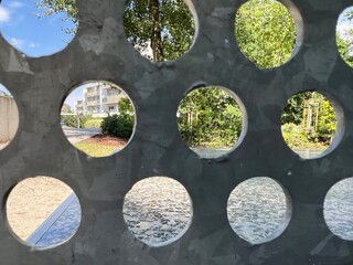 Urban View Through Circular Openings in Metal Panel
