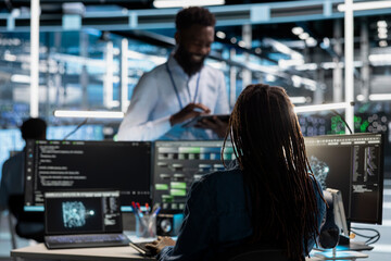 Software developer in data center uses AI technology for machine learning workloads. IT specialist...
