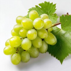 A bunch of green grapes with leaves on a white surface