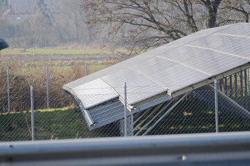 Side View of Solar Panels in Spring Behind Metal Fence and five Solar Panels missing