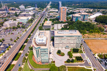 Aerial view of Tysons Virginia with metro line and modern buildings under summer sky