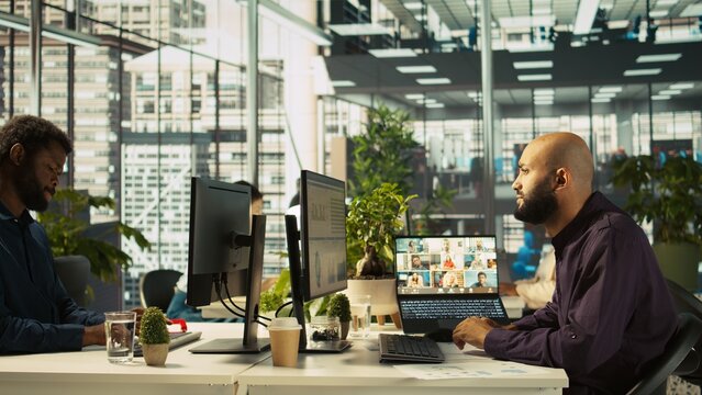 Employee having online discussion with coworkers in video call meeting, working from office. Staff member in video conference over the internet with teleworking colleagues, camera B - Powered by Adobe