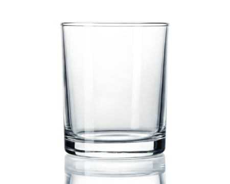 A clear glass tumbler with a thick base sits on a reflective surface against a black background