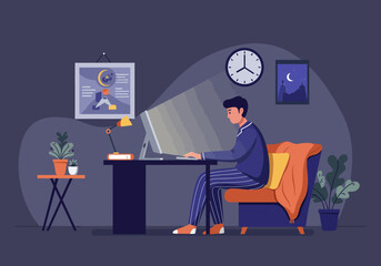 Man in pajamas working on a laptop at a desk in a dimly lit home office late at night, illuminated by screen light.