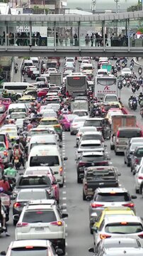 BANGKOK, THAILAND - AUGUST 2024 : High angle view of traffic jam in busy rush hour at downtown shopping area. Transportation and street traffic concept video.