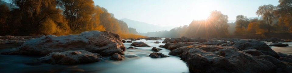 Serene autumn river landscape at sunrise with boulders and trees