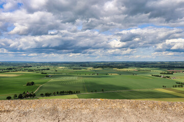 landscape with green field and blue cloudy sky