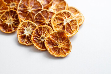 Pile of dried orange slices on a white background. Dried fruits for mulled wine and New Year's decor. Citrus for tea and aromatherapy
