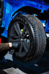Drift Car Wheel and Tire Mounting. Performance wheel install on tuned suspension with visible brake...