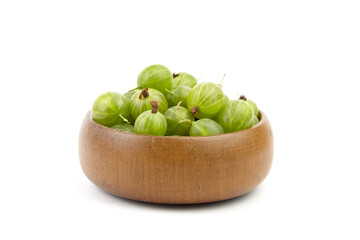 Fresh green gooseberries in a wooden bowl, showcasing their vibrant color and natural texture,...
