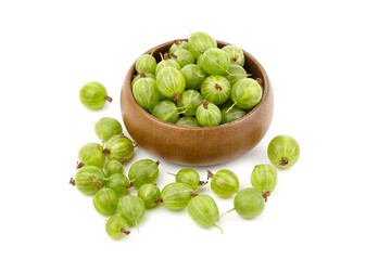 Fresh green gooseberries in a wooden bowl, surrounded by scattered berries on a white background, showcasing vibrant colors and natural textures for culinary use