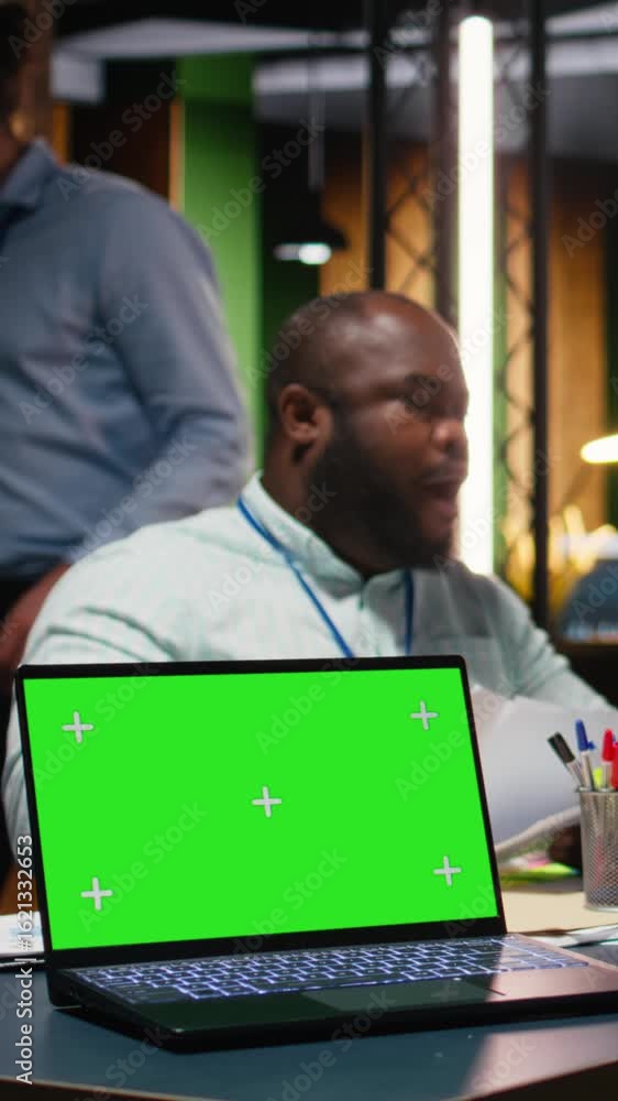 Poster vertical video team of office workers meeting late at night next to copy space screen, attending a l