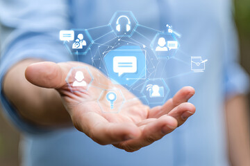 Customer service and support solution, Businessman offering digital support with global communication icons. 24/7 service, Contact us page, online helpdesk, Ai chatbot, email, Ai assistance.