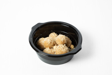 Homemade sweet hazelnut balls covered in crumbs, served on a plate. Isolated on white background