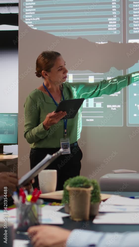 Poster vertical video business partners reviewing monthly data reports in night time meeting, developing in