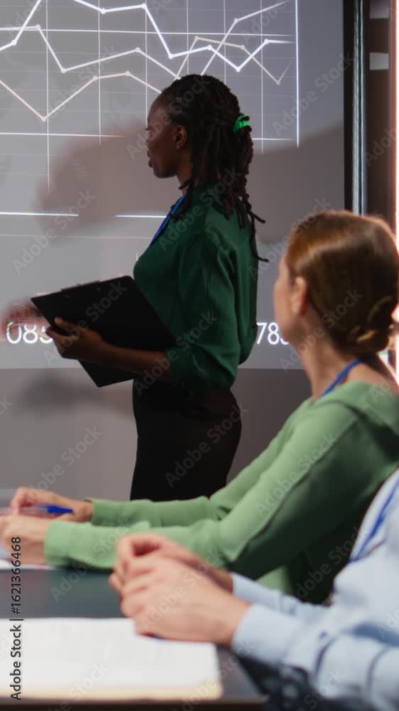 Poster vertical video diverse business consultants reviewing targets and proposals for a project agenda, ex