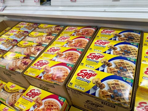 Carton boxes of assorted flavors Kellogg's Eggo brand frozen belgian waffles for sale in a supermarket freezer