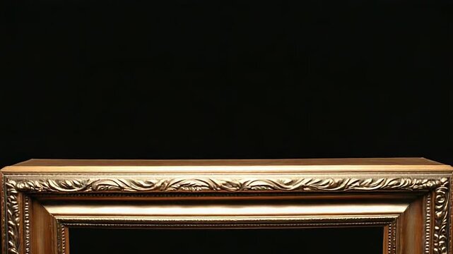 Elegant ornate gold picture frame on black background