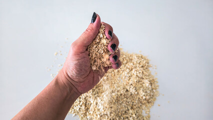 Raw Oats in Hand and Basket