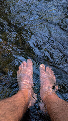 Point of View of a Person's Feet Submerged in a Cool River