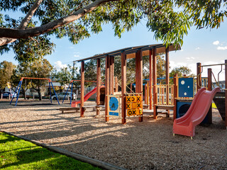 Children’s playground in Footscray, Melbourne, Australia, featuring slides, swings, climbing structures,  and soft mulch ground covering. A safe space for outdoor play and community recreation.