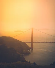 Tableau sur plexiglas Pont du Golden Gate Golden gate bridge at sunset with a beautiful warm fog   © Anthony