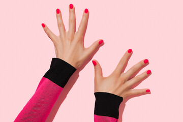 Womans hands with pink nail design. Manicure, pedicure beauty salon concept. Deep long shadows