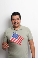 A 40-year-old dark-skinned Latino man displays the American flag and works to obtain citizenship