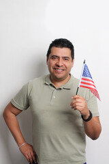 A 40-year-old dark-skinned Latino man displays the American flag and works to obtain citizenship