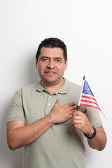 A 40-year-old dark-skinned Latino man displays the American flag and works to obtain citizenship
