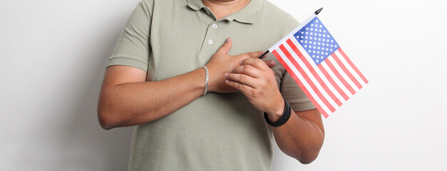 A 40-year-old dark-skinned Latino man displays the American flag and works to obtain citizenship