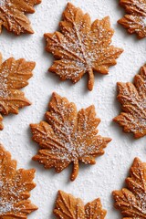 Leaf-shaped gingerbread cookies overhead, cozy and minimal with autumn tones.