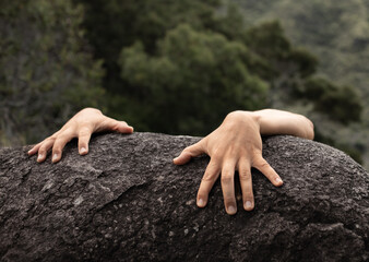 lone climber hand gripping rock edge symbolizes hopelessness, danger, risk