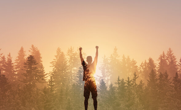 rear view carefree freedom successful male standing confident looking out o the forest sunrise  summertime sunset moment nature background