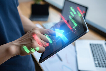 Person using tablet displaying stock market graph with an upward arrow overlaying the screen