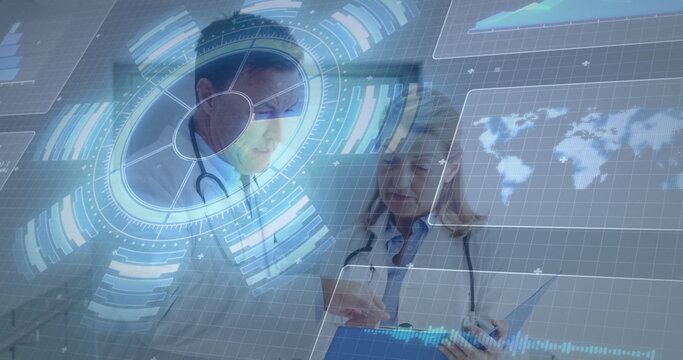 Reviewing hologram data senior doctors in white coats and stethoscopes in clinic, with blue tablet