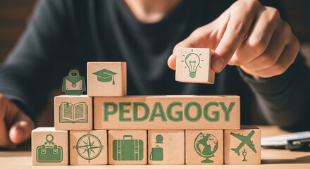 Person placing a wooden block with a lightbulb on top of pedagogy blocks with education icons