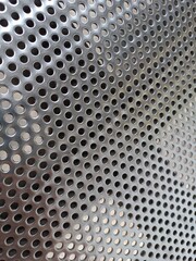 The pattern of holes on the stainless steel chair seat
