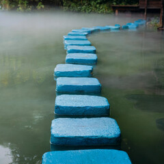 Blue Stepping Stones Path Through Foggy Water