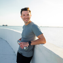 Enjoying a refreshing moment by the waterfront after a workout