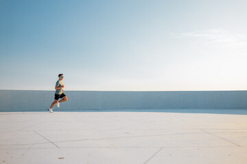 Runner enjoying a morning sprint on a rooftop with a city view